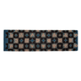A scarf laid flat on a white background with a geometric pattern in blue, black and pink shapes.