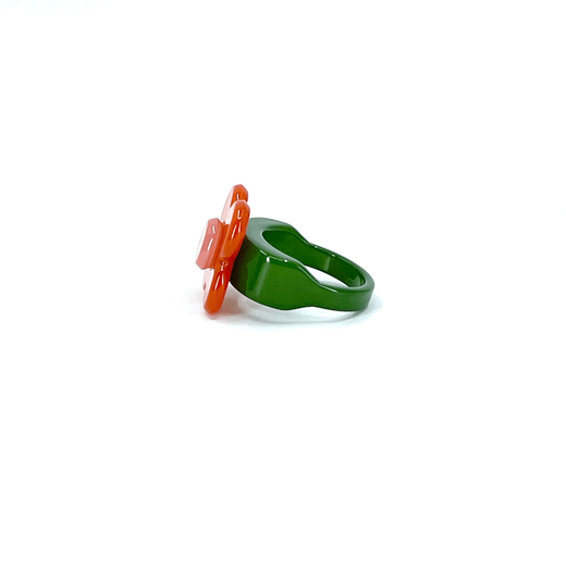 An orange and green flower shaped ring.