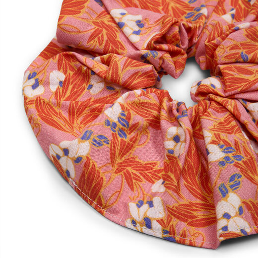 A close up of a cotton scrunchie with a floral pattern.