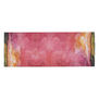 A scarf featuring a pink, red and green abstract pattern.